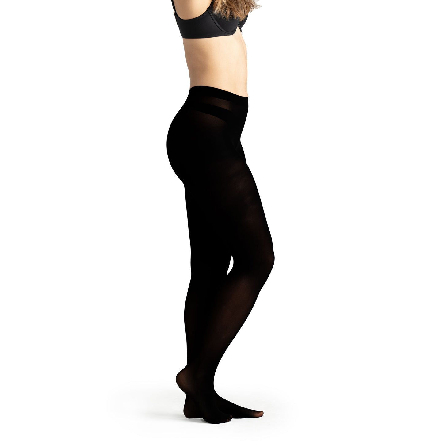 Woman standing in relaxed pose wearing opaque black fleece-lined tights with high waistband, showcasing warm thermal leggings ideal for winter layering, casual outfits, or cold-weather lounging