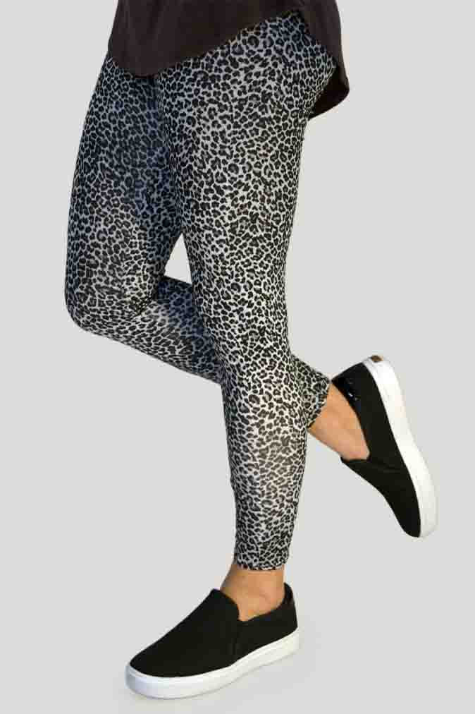 Woman wearing high-waisted brown cheetah print leggings paired with a black sports bra. Comfortable and stretchy animal print leggings perfect for workouts, yoga, or casual wear. Full-length design with a body-hugging fit, photographed barefoot in a studio with a neutral background.