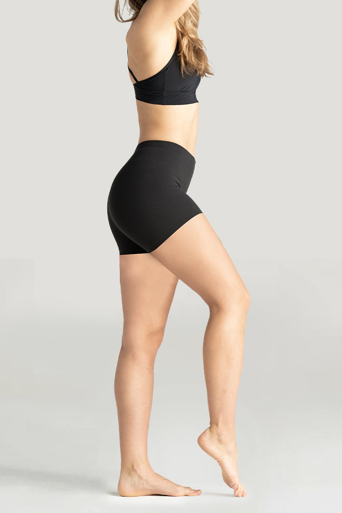 Women's seamless black short shorts lightweight anti-chafing slip shorts for everyday wear in a side profile