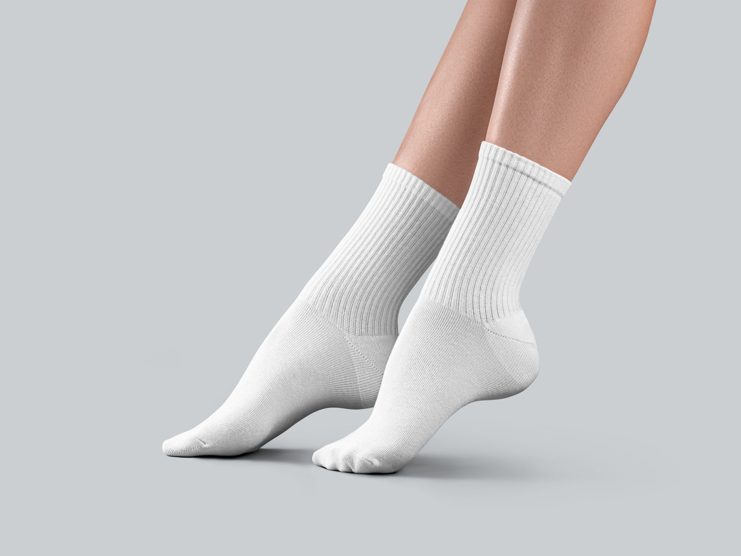 White socks worn by a person on a gray background
